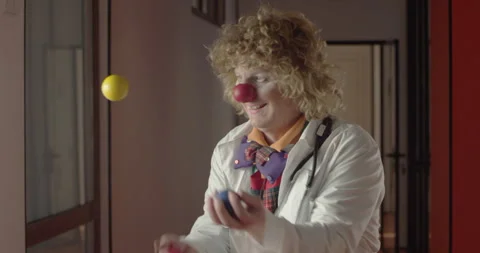 Clown with a stethoscope juggling the balls Stock Footage 283047591