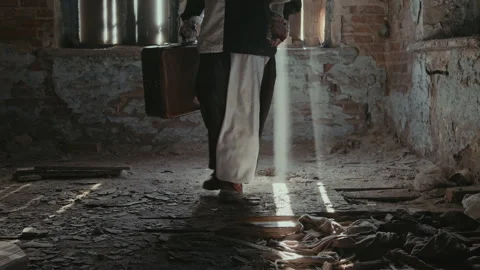 Clown with Suitcase Walking through Room with Shabby Floor and Walls Stock Footage 250949859