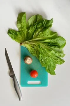 Clown's Face From Vegetables on Cutting Board Stock Photos
