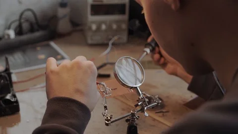 Clse up of a man fxing microscheme Stock Footage 86568099