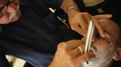 Clse up, pull back of shaving man with a straight razor, Old Fashion Barber Shop Stock Footage 45523820