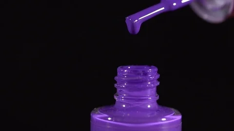Clsoeup of violet nail polish drpping into the bottle slow motion Stock Footage 76193481