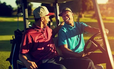 Clubbing at its best. two golfers riding in a cart on a golf course. Stock Photos