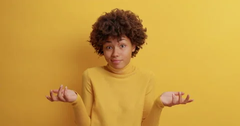 Clueless dark skinned woman throws up hands and shrugs shoulders in slow motion Stock Footage 142328425