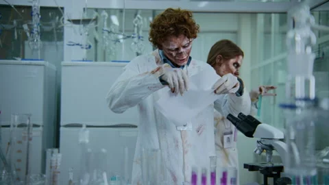 Clueless Living Corpse Technician Eating Research Document in Laboratory Stock Footage 293782376