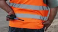 Clumsy fat male security with walky-talky in orange uniform HD Footage