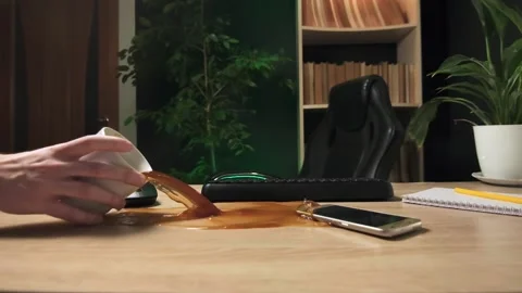 A clumsy office worker unfolded a cup of coffee on the desktop Stock Footage 264875766