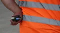 Clumsy security with walky-talky in orange uniform standing HD Footage
