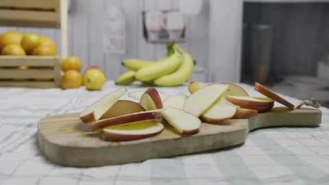 Cluster of apple slices on cutting board in beautiful kitchen - tracking Stock Footage 341195344