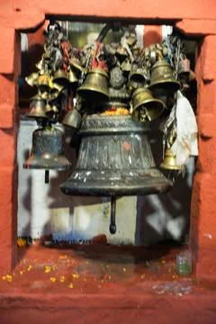 A cluster of bells in a wall opening. Фото