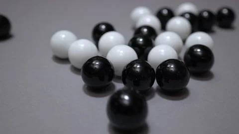 Cluster of black and white balls reconfigures upon impact Stock Footage 147463900