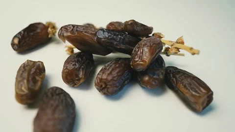 Cluster of Dried Dates on Light Surface, A cluster of dried dates on a ligh.. Stock Footage 304974865