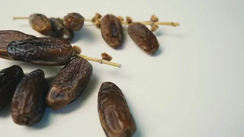 Cluster of Dried Dates on Light Surface, A cluster of dried dates on a ligh.. 動画素材 304974897