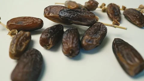 Cluster of Dried Dates on Light Surface, A cluster of dried dates on a ligh.. 動画素材 304974940