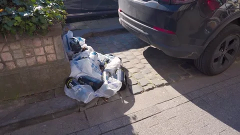 Cluster Of Empty Nitrous Oxide Cylinders Dumped By Curb Next To Parked Car Stock Footage 332085564