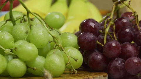 Cluster of fresh green and red grapes in kitchen - closeup, panning shot Stock Footage 341194023