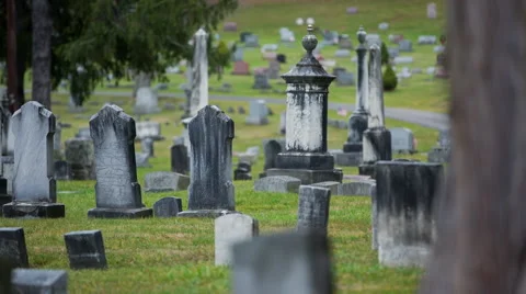 A cluster of old graves in a cemetery Stock Footage 58446466