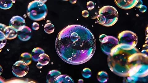Cluster of reflective soap bubbles drifts against black Video stock 317215928