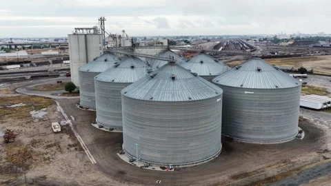 Cluster of steel grain silos rises at industrial storage facility near Fresno Stock Footage 339907969