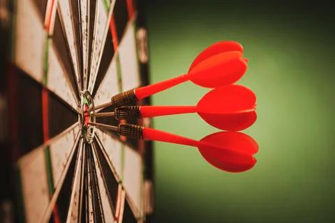 Cluster of three red darts on a target Stock Photos