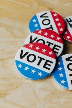 Cluster of vote badges on a marble surface Stock Photos