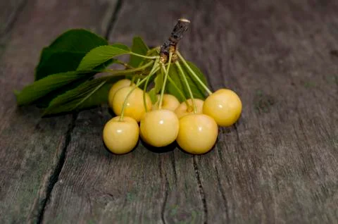 Cluster of white sweet cherry on an old board Stock Photos
