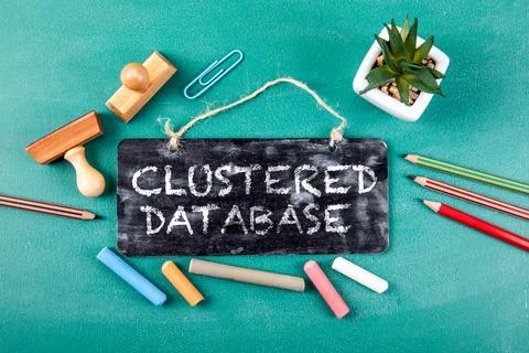 Clustered Database Concept Written on Chalkboard Sign with Office Tools Stockfoto's