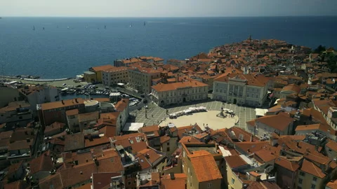 Clustered rooftops and main square with central statue at sunset in Piran Stock Footage 318641313