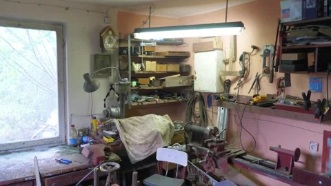 The cluttered and busy atmosphere of a workshop, filled with various tools,.. Stock Footage 282978673