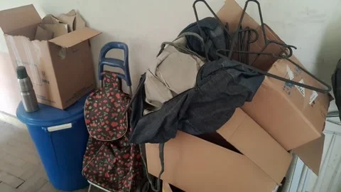 Cluttered cardboard boxes and shopping cart in static video footage clip Stock Footage 339349186