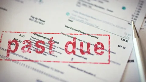 On a cluttered desk surrounded by scattered documents and a calculator a red Stock Footage 336569844