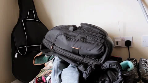 Cluttered Room With Backpack, Clothes, And Guitar Case Indoors - 4K Stock-Footage 344426150