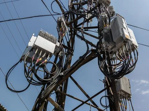 Cluttered utility pole with assortment of electronic equipment, including Stock Photos