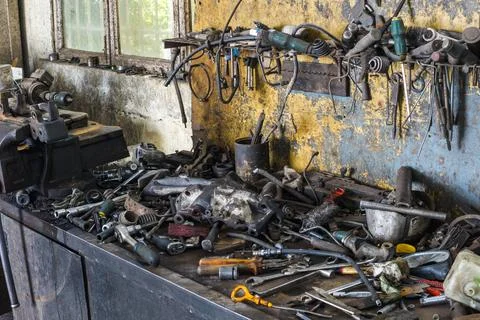 Cluttered Workbench with Tools and Mechanical Parts Stock Photos