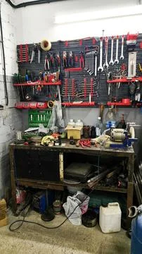 Cluttered workbench with tools, wrenches, Stock Photos