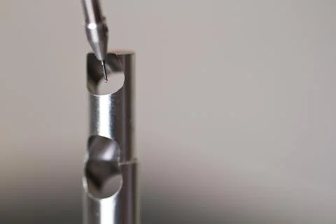 CMM Programming Probe by Small Metal Part on White Background Close-Up Stockfoto's