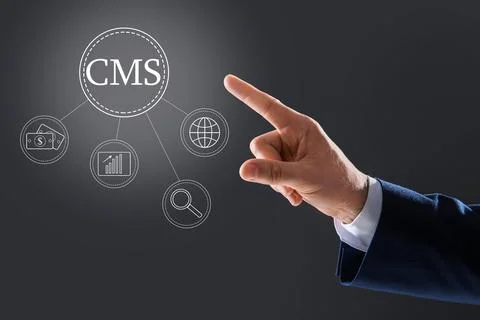 CMS. Man using virtual screen, closeup. Scheme with icons on dark background Foto stock