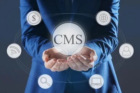 CMS. Man using virtual screen, closeup. Scheme with icons on dark background Foto stock