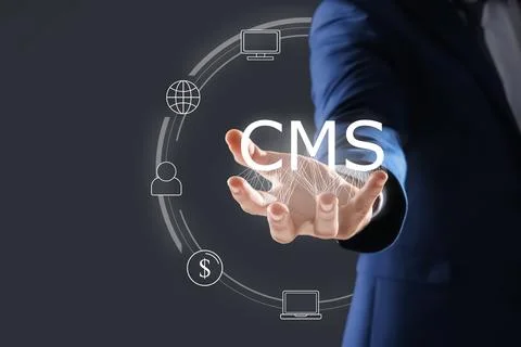 CMS. Man using virtual screen, closeup. Scheme with icons on dark background Foto stock