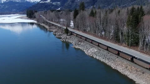 Cn Coal train drone shot alongside a river 4K footage Stock Footage 149142281
