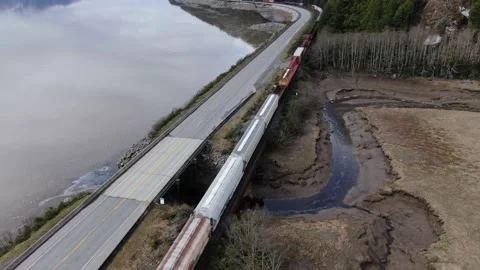 CN Rail Eastbound train drone orbit crossing a rail bridge 4K footage Stock Footage 149380153