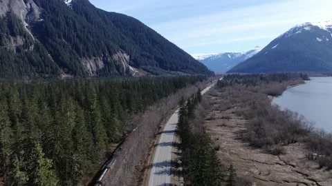 CN Rail Grain train overhead passing by Kwinitsa Station 4k Drone Stock Footage 149147017