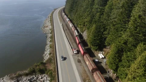 CN train Eastbound grain train departing from a siding along the Skeena River Stock Footage 149148189