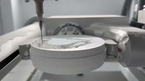 CNC dental milling machine carving out shape of artificial teeth in the lab Stock Footage 183532133