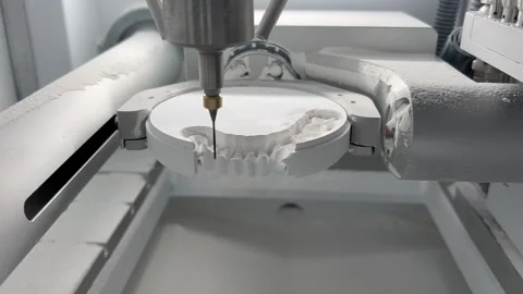 CNC dental milling machine carving out shape of artificial teeth in the lab Stock Footage 194499720