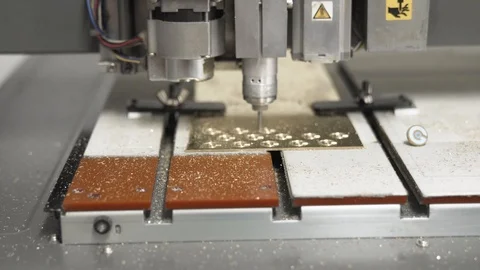 CNC engraving and cutting machine milling a small metal plate dolly shot Stock Footage 101258199