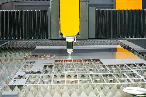 CNC fiber laser cutting machine cutting precise parts from a sheet metal plat Stock Photos
