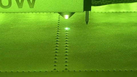 CNC laser cutter engraving pattern on green leather close-up Видео 335942172