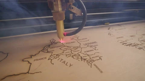 Cnc laser cutting machine cuts world map on wooden plank and plywood  Stock Footage 147121643