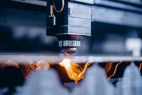 CNC laser machine cutting sheet metal with light spark. Technology plasma Stock Photos